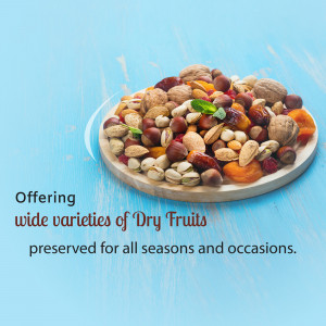 A white plate filled with a variety of dry fruits on a light blue wooden surface.