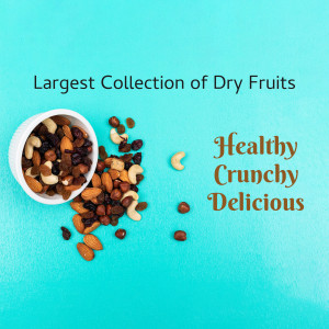 A bowl and scattered assortment of mixed dry fruits on a turquoise background.