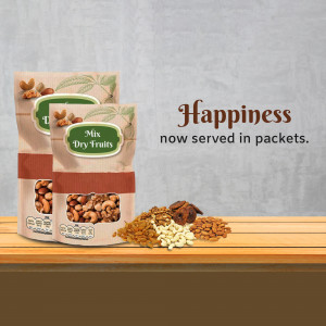 Packets of mix dry fruits with scattered nuts on a wooden surface