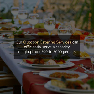 Outdoor dining table set for a large event with food and drinks