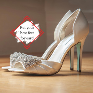 Close-up of white wedding heels with crystal embellishments