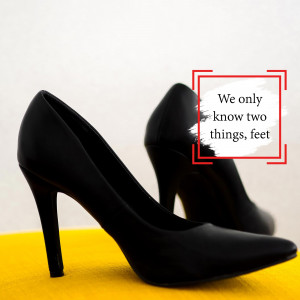 Close-up of a pair of black high heel shoes on a yellow surface with text overlay.