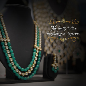 Close-up of emerald and gold necklaces and earrings on display
