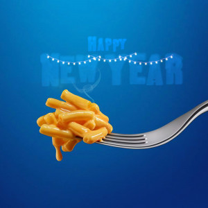 A forkful of macaroni and cheese with 'Happy New Year' text and string lights.
