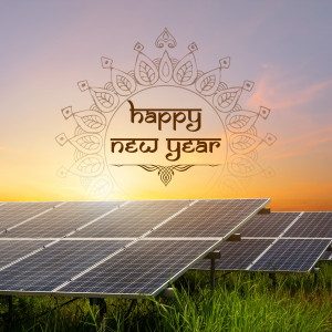 Solar panels with a Happy New Year greeting against a sunset background