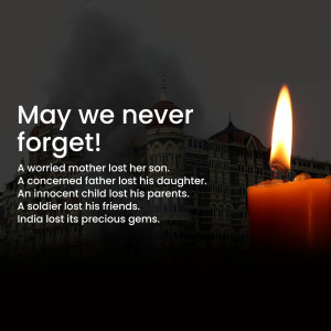 Candle lit in remembrance of the 26/11 Mumbai attacks with the Taj Mahal Hotel in the background.