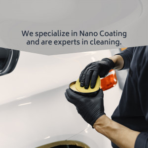 Close-up of a professional applying nano coating to a car's surface.