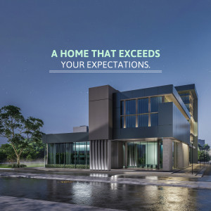 A modern, two-story house with illuminated windows at twilight.