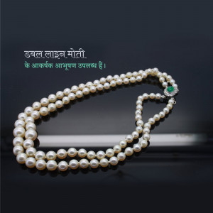 Close-up of a double-strand pearl necklace with an emerald pendant.