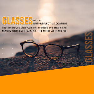 Close-up of eyeglasses with anti-reflective coating on a rocky surface with a sunset background.
