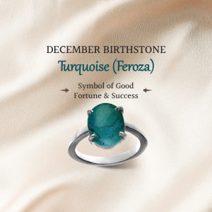 Silver ring with a turquoise gemstone, representing the December birthstone.