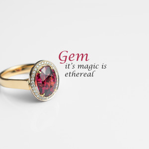 Close-up of a gold ring with a large oval-cut garnet gemstone surrounded by sparkling diamonds.