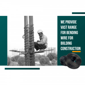 Construction worker bending rebar with wire coils and building in the background.