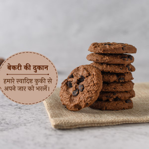 A stack of freshly baked chocolate chip cookies on a linen cloth with a Hindi sign.
