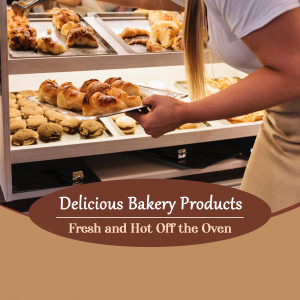 A bakery worker removing a tray of freshly baked pastries from an oven.