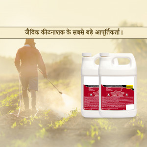 Farmer spraying organic pesticide in a field with pesticide containers in the foreground.