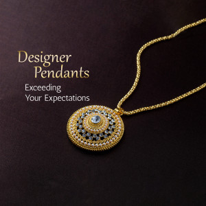 Close-up of a gold pendant with intricate detailing and a blue gemstone.