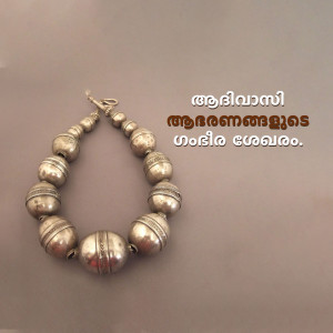 Close-up of a vintage silver anklet with spherical beads and intricate designs.