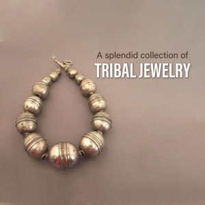 Close-up of a silver tribal bracelet with spherical beads.