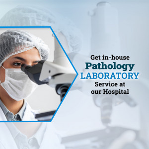 A healthcare worker looking through a microscope in a pathology laboratory.