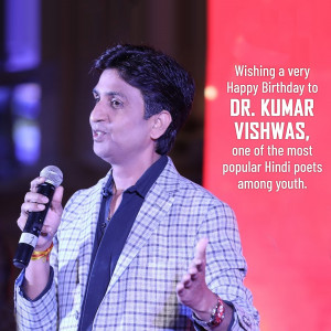Dr. Kumar Vishwas speaking into a microphone at an event.
