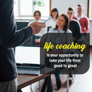 A life coach presenting to a group of people in a classroom setting.