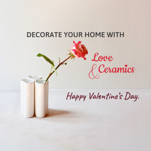 White ceramic vases with a pink rose and Valentine's Day message