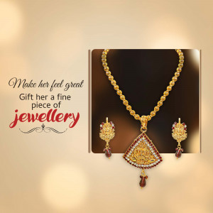 Close-up of a gold necklace and earring set with a red and gold pendant.