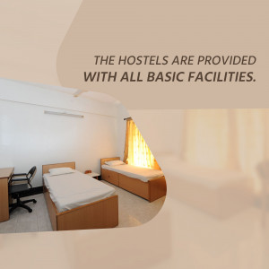 A clean and simple hostel room with two single beds and basic furniture.