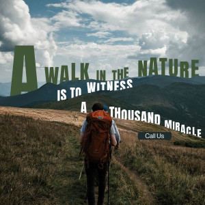 Two hikers walking on a mountain trail with a scenic view.