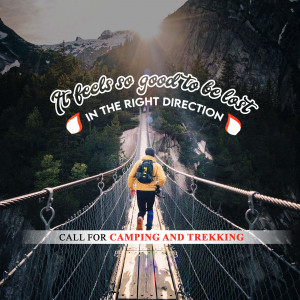 Person walking on a suspension bridge in the mountains with motivational text.