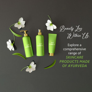 Green skincare products with white flowers on a dark background