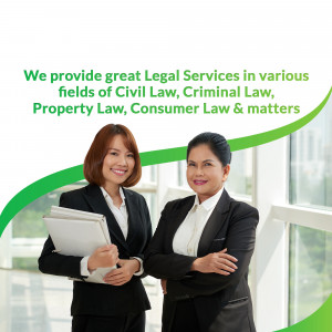 Two female lawyers smiling and holding legal documents.