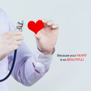 A doctor's hand holding a red heart with a stethoscope, symbolizing heart health.