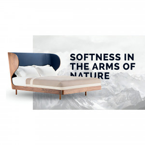 A modern bed with a wooden frame and blue headboard against a mountain backdrop.