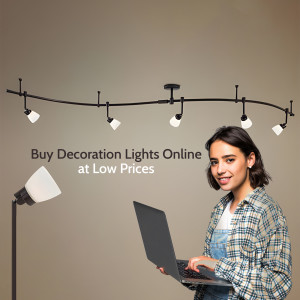 Woman using laptop with track lighting in the background