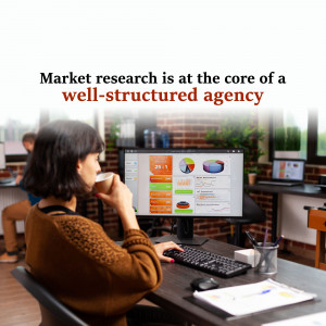 Woman working on a computer analyzing market research data in an office setting.