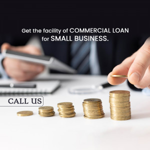 Hand placing a coin on a stack of coins with a blurred office background and text promoting commercial loans for small businesses.