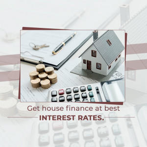 Wooden house model, keys, calculator, and coins representing home finance and interest rates.