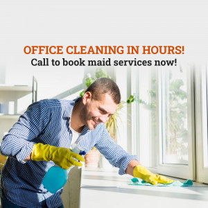 Man cleaning an office window with spray and cloth