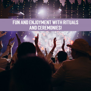 Crowd enjoying a concert or event with hands raised in the air.