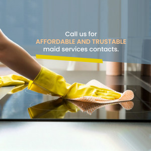Woman in yellow gloves cleaning a kitchen countertop