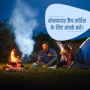 Couple enjoying a bonfire while camping at night