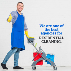Smiling cleaner giving a thumbs up with cleaning equipment