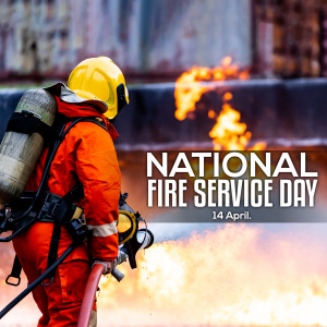 Firefighter in action with flames in the background and text 'National Fire Service Day'