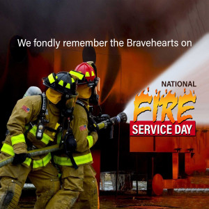 Two firefighters in full gear working with a hose during National Fire Service Day.