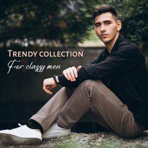 A young man in a black shirt and khaki pants posing for a fashion advertisement.