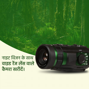 Close-up of a camera with a wide-range lens against a lush green forest background.