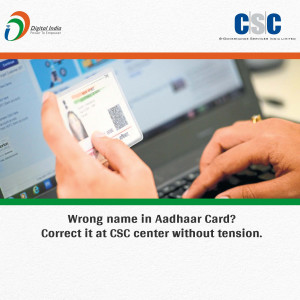 Image showing a hand holding an Aadhaar card displayed on a laptop screen, with text about correcting name errors.