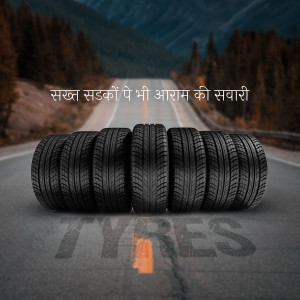 Stack of tyres on a road with text in Hindi